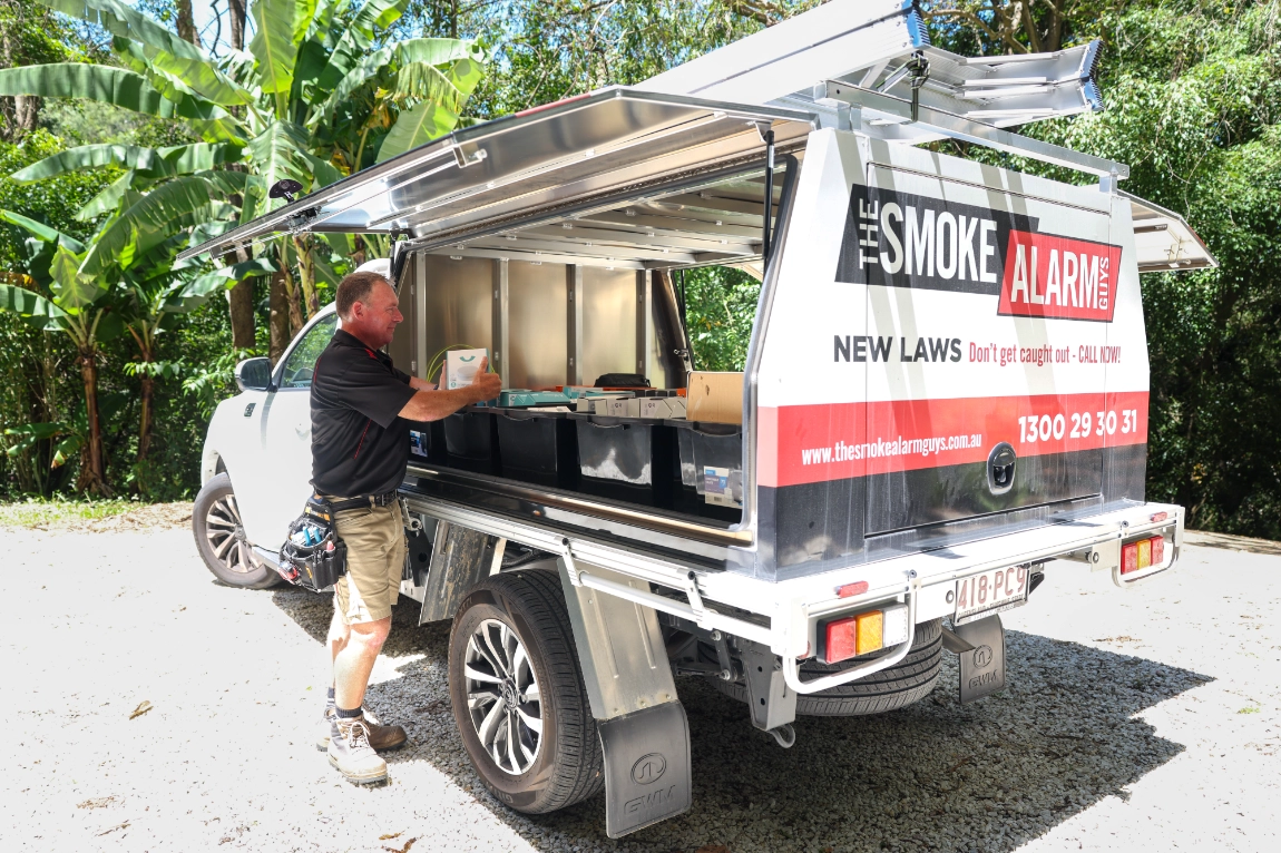 smoke-alarm-technician-organizing-service-truck